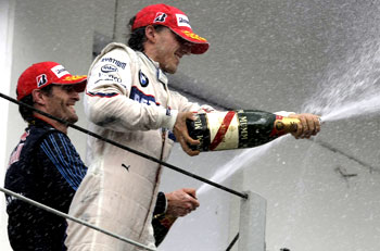 Robert Kubica (right) and Mark Webber celebrate on the podium at Interlagos