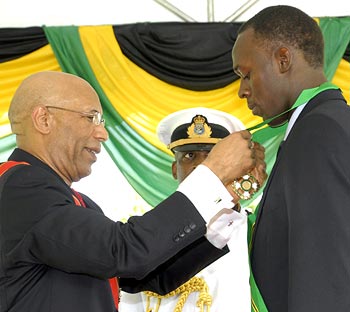Usain Bolt receives the Order of Jamaica from Jamaica's Governor General Patrick Allen