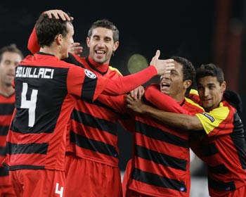 Squillaci of Sevilla celebrates with team mates during their Champions League soccer match in Stuttgart