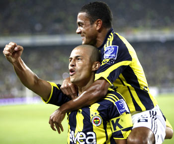 Alex de Souza and Gokcek Vederson (top) of Fenerbahce celebrate after scoring against Galatasaray during their Turkey Super League derby match at Sukru Saracoglu Stadium in Istanbul on Sunday