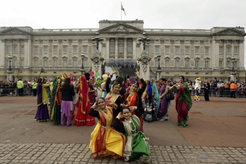 Dancers pose for photographs outside Buckingham Palace