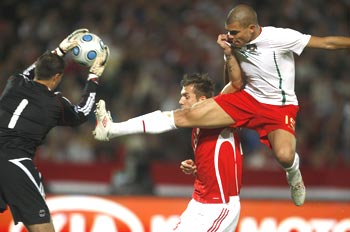 Portugal's Pepe is air borne as he tries to score past Hungary's 'keeper Gabor Babos