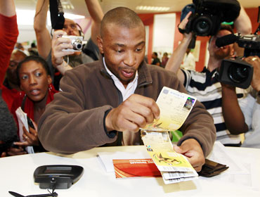 Mithethwa Sibusiso of South Africa shows his tickets as he is the first person who obtained World Cup tickets