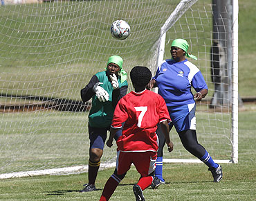 Members of Vakhegula Vakhegula Football Club play a practice match against Metro Rail Eagles team at Esselen Park in Johannesburg