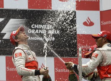 Jenson Button celebrates with Lewis Hamilton