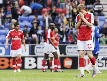 Arsenal players react after losing the match