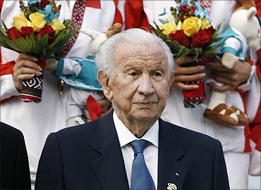 Former International Olympic Committee chairman Juan Antonio Samaranch poses with medallists during the award ceremony for the women's double tennis final at the 15th Asian Games in Doha December 14, 2006