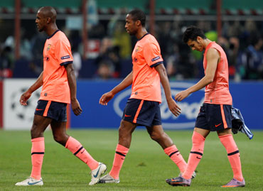 Barcelona players walk off the pitch after the match