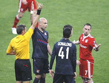 Franck Ribery (right) is shown the red card by referee Roberto Rosetti (left)