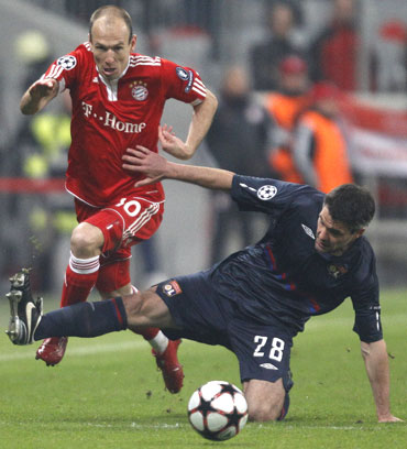 Arjen Robben (left) is challenged by Jeremy Toulalan