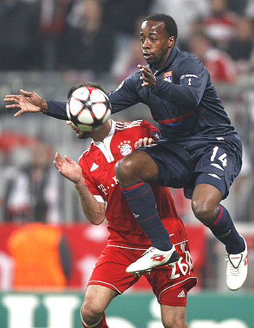 Sidney Govou (right) of Olympique Lyon and Diego Contento of Bayern Munich vie for possession