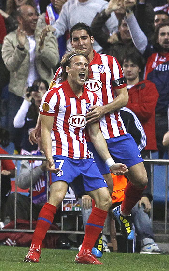 Atletico Madrid's Diego Forlan (left) celebrates with Raul Garcia after scoring against Liverpool on Thursday
