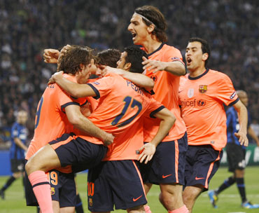 Barcelona players celebrate after scoring against Inter