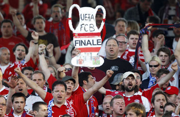 Bayern supporters hold a mock trophy during the semi-final