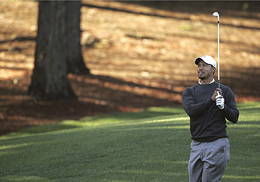 Tiger Woods watches his shot from the third fairway during a pro-am event before play in the Quail Hollow Championship