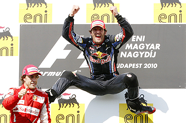 Red Bull's Mark Webber (right) and Ferrari's Fernando Alonso celebrate on the podium after the Hungarian GP
