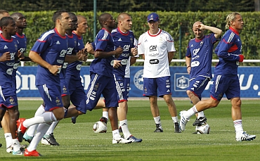 Coach Laurent Blanc (in white) watch France's soccer team players during a training session