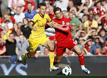 Liverpool's Fernando Torres (right) and Arsenal's Laurent Koscielny vie for possession