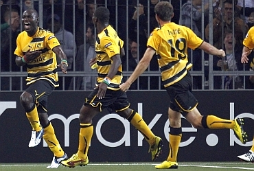 BSC Young Boys Benvenue and team-mates celebrate after scoring the second goal against Tottenham Hotspur
