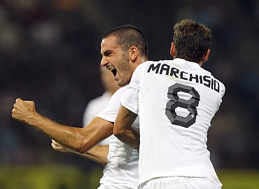 Juventus' Bonucci and Marchisio celebrate after Bonucci scored a goal during their Europa League playoff match in Graz