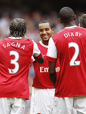 Arsenal's Theo Walcott (centre) celebrates with teammates after scoring against Blackpool during their English Premier League match at The Emirates Stadium on Saturday