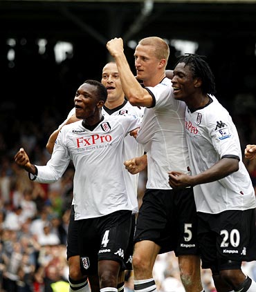 Fulham's Brede Hangeland (centre) celebrates his goal with team mates