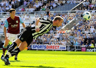 Newcastle United's Kevin Nolan (right) heads to score against Aston Villa