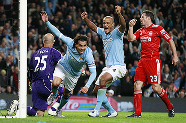 Manchester City's Carlos Tevez (2nd from left) celebrates after scoring against Liverpool on Monday