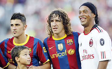 AC Milan's player Ronaldinho (right) with Barcelona's Carles Puyol (centre) and David Villa (left) before their friendly match at Camp Nou on Wednesday