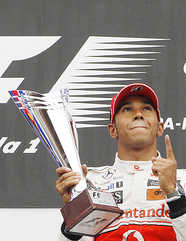 McLaren's Lewis Hamilton celebrates on the podium after winning the Belgian Grand Prix on Sunday