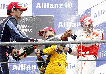 McLaren's Lewis Hamilton (right) sprays champagne with Renault's Robert Kubica (centre) and Red Bull's Mark Webber (left) on the podium