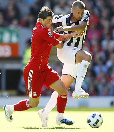 Liverpool's Fernando Torres (left) and West Bromwich Albion's Gabriel Tamas (right) vie for possession