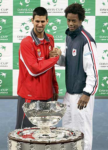Serbia's Novak Djokovic (L) and France's Gael Monfils pose with the Davis Cup trophy