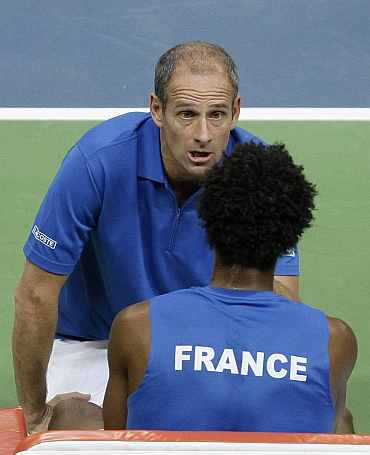 Guy Forget gives instructions to Gael Monfils during his Davis Cup final match against Serbia's Djokovic in Belgrade