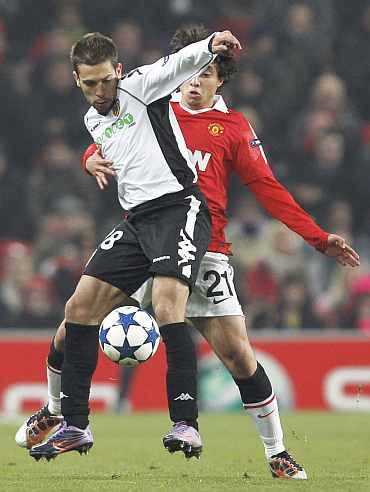 Manchester United's Rafael challenges Valencia's Jordi Alba during their Champions League Group C match at Old Trafford