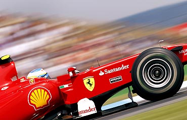 Fernando Alonso steers his Ferrari car
