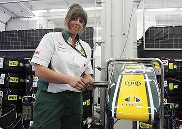 Lotus Formula One mechanic Antonia Scott of Britain works at her team's pit box