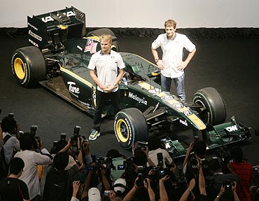 Lotus F1 F1 drivers Heikki Kovalainen of Finland (left) and Jarno Trulli of Italy pose with the Lotus Cosworth T127