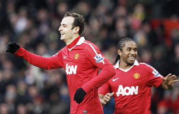 Berbatov celebrates with Anderson after scoring the second goal