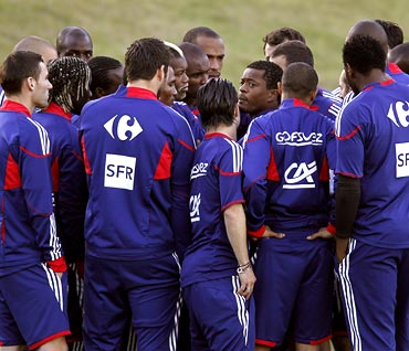 France football captain Patrice Evra (centre) speaks to his team-mates