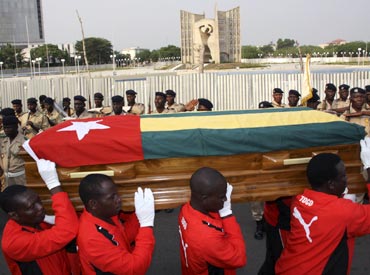 Pallbearers carry the coffin of Togolese assistant soccer coach Amalete Abalo during the funeral service in Lome, on January 15, 2010