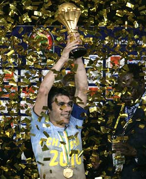 Egypt's captain Ahmed Hassan holds the trophy after his side's victory in their African Nations Cup final soccer match against Ghana