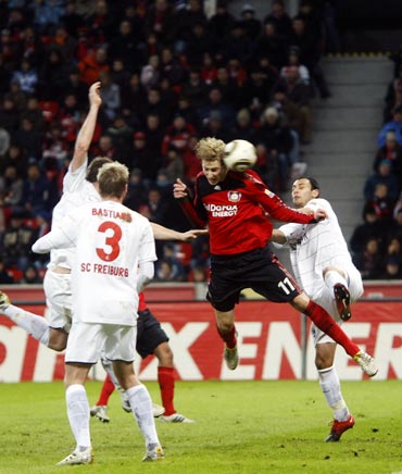 Bayer Leverkusen's Stefan Kiessling (centre) scores a goal against Freiburg