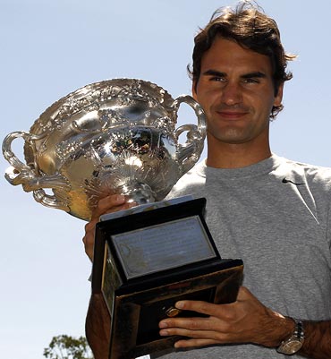 Roger Federer poses with the Australian Open trophy