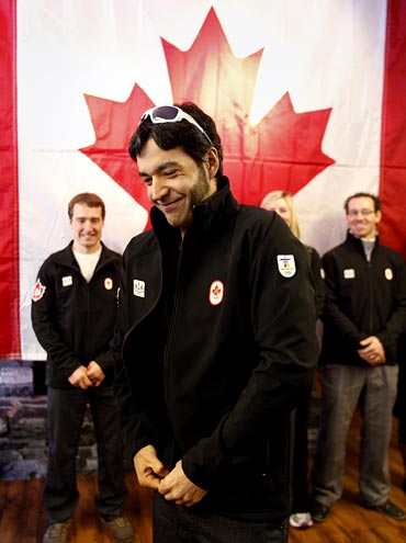 Brian McKeever puts on his Team Canada Olympic jacket after he was named in the Olympic Cross Country ski team