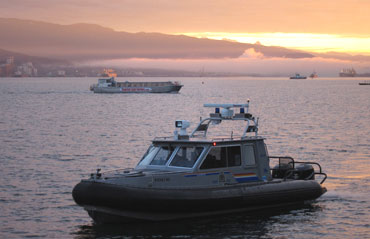 A Royal Canadian Mounted Police boat patrols along Burrard Inlet ahead of the 2010 Winter Games in Vancouver