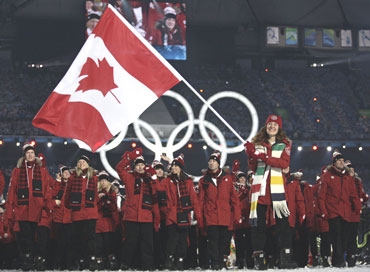 Flag bearer Hughes of Canada leads her country's delegation during the opening ceremony