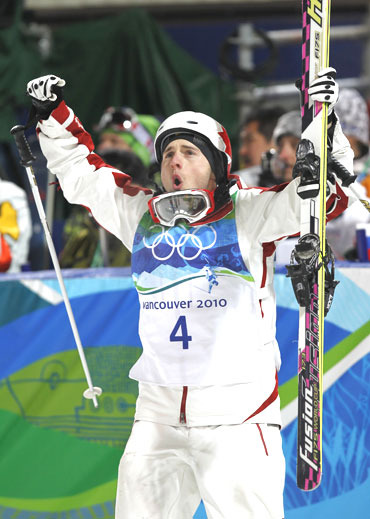 Canada's Alexandre Bilodeau celebrates after seeing his score during the men's freestyle skiing moguls final on Cypress Mountain