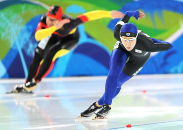 Lee Sang-Hwa of South Korea (right) and Wolf of Germany compete in the women's 500 metres speed skating race
