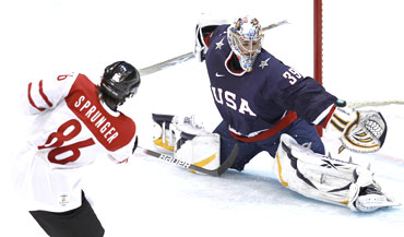 US goalie Ryan Miller blocks a shot from Switzerland's Julien Sprunger during their men's ice hockey game